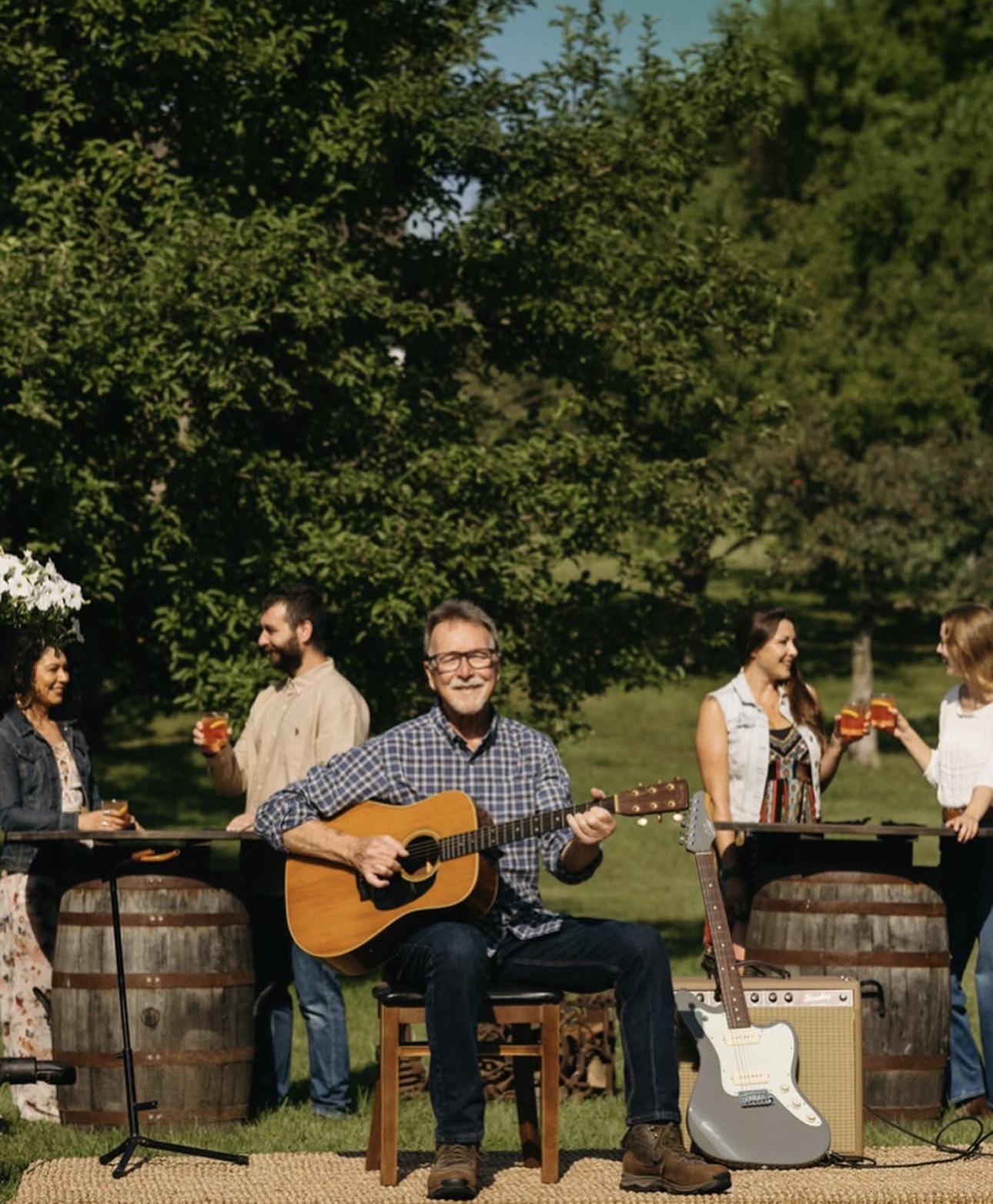 Guests at outdoor barrel tables