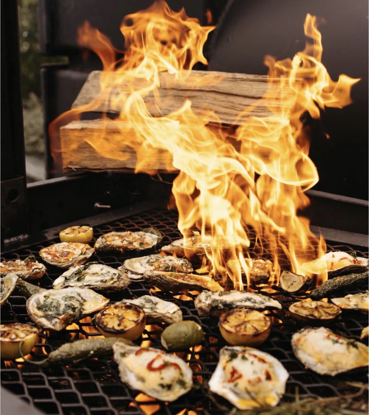 Oysters on grill with open flame