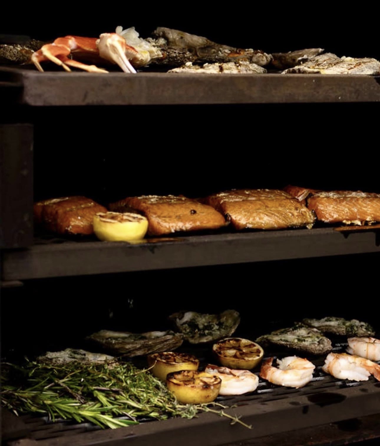 Multi-rack smoker with salmon and shrimp